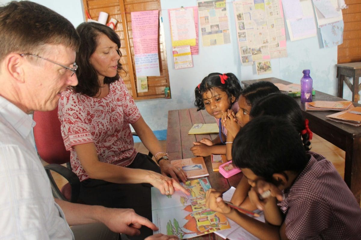 Family teaching children in India