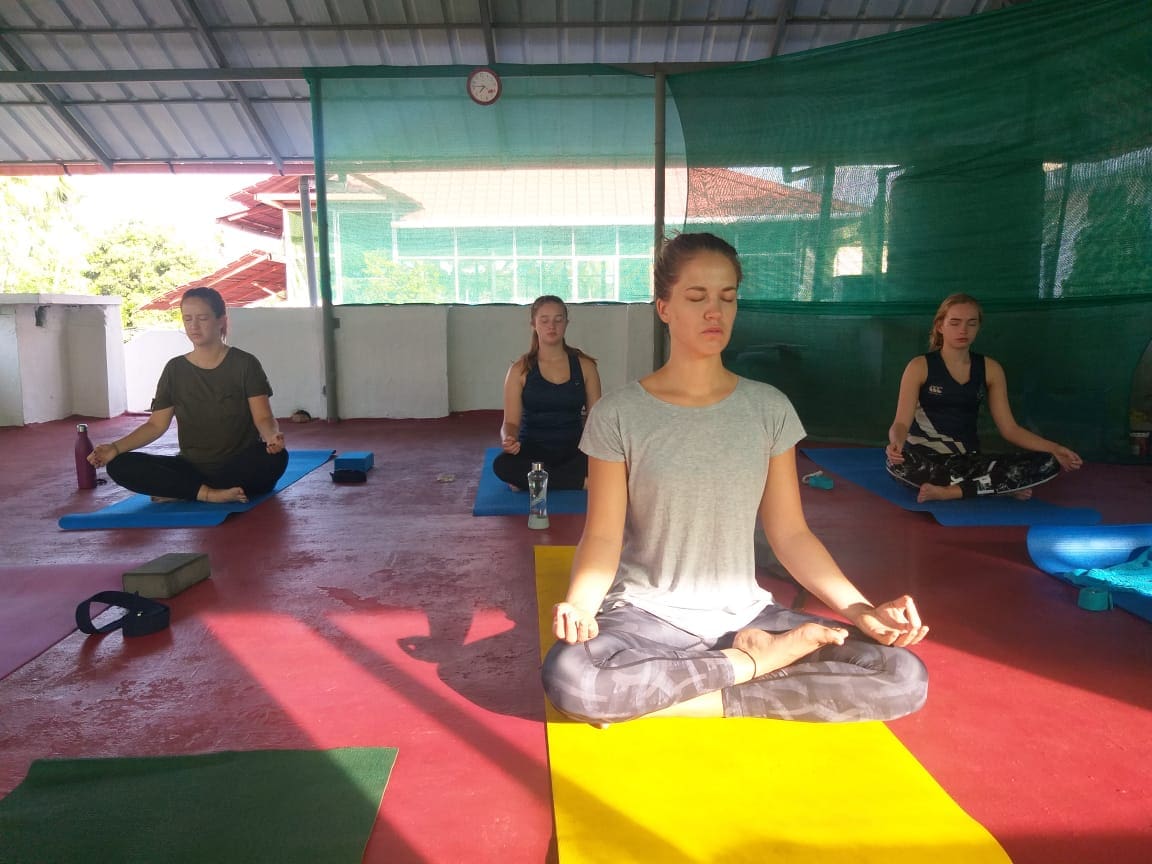 Learning yoga in India