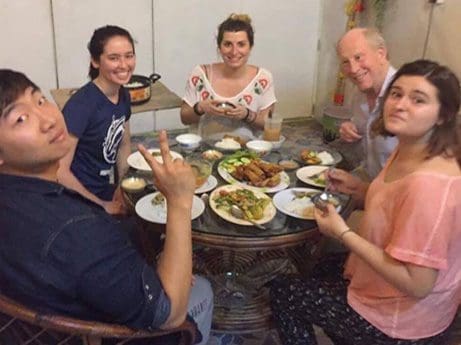 Volunteers in Cambodia enjoying a meal at home