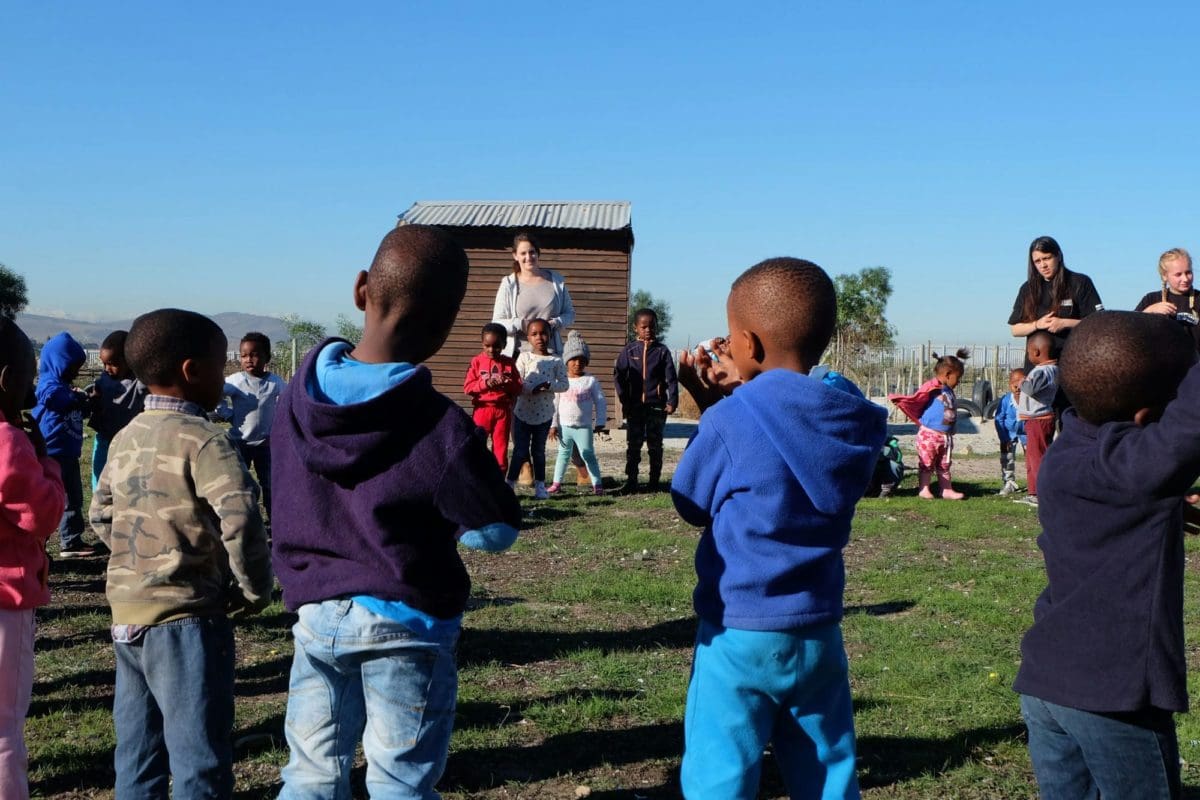 South Africa Volunteering Teaches and volunteers cleaning Kids playing 2 Dance ring