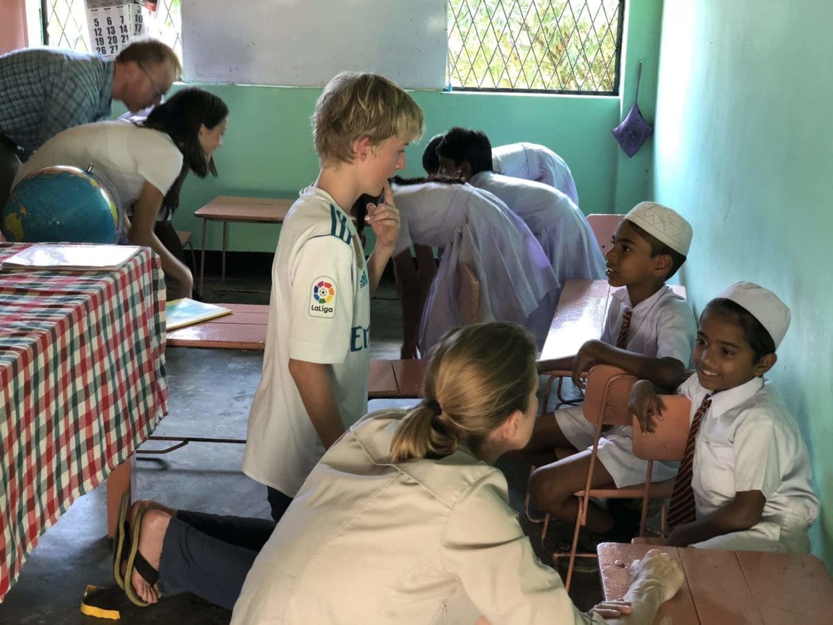 Family volunteers teaching children in school