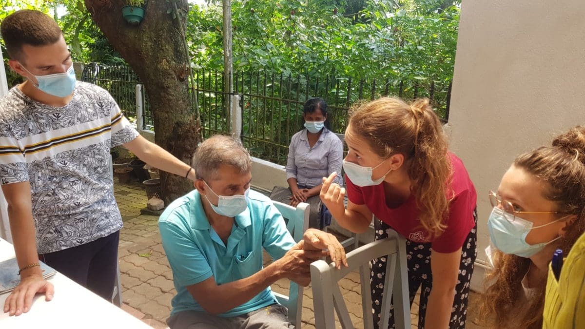 Physiotherapy volunteer with patient